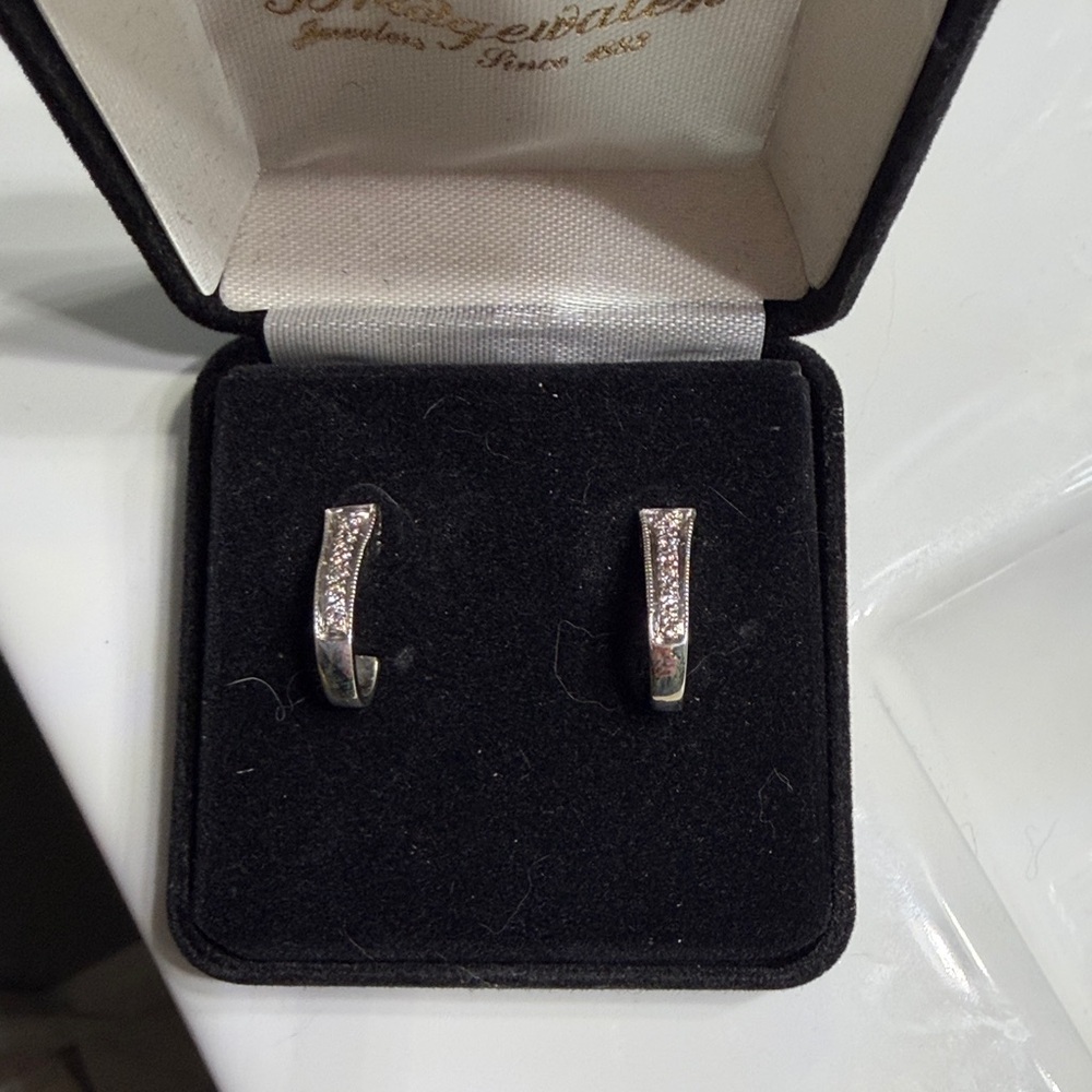 Elegant 14k White Gold half hoop diamond earrings.